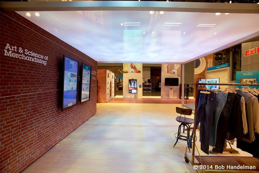 The Art & Science of Merchandising area with a brick wall, screens, a vintage stool and clothing racks