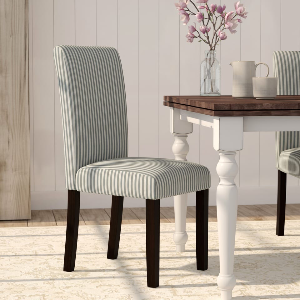 3D rendering of a striped upholstered dining chair at a table